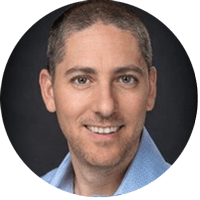 Portrait of a smiling person symbolizing efficient ITSM solutions with SysAid, against a dark background, showcasing professional expertise. - SysAid