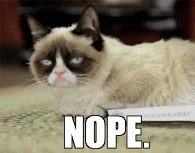 A grumpy-looking cat with dark facial markings lies on a book, with the word "nope" appearing in a caption below.