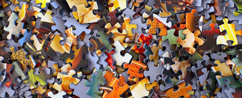 A collection of colorful jigsaw pieces symbolizes the integration of ITSM solutions like SysAid's Service Desk capabilities. - SysAid