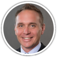Professional with short hair in a suit, symbolizing SysAid's ITSM and Service Desk efficiencies, against a gray backdrop. - SysAid