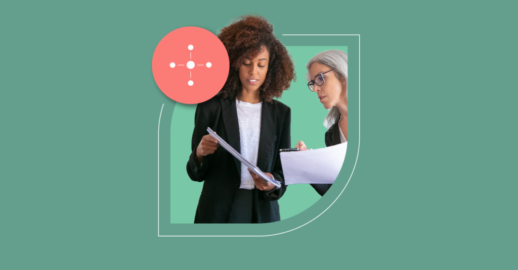 Two women review documents with a clipboard, illustrating ITSM Change Enablement. Green backdrop with directional arrows icon enhances focus. - SysAid