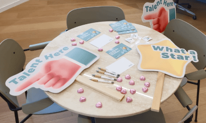 A round table with talent signs and notecards, symbolizing how SysAid ITSM helps manage and support diverse teams. - SysAid