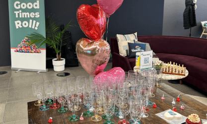 A lounge table setup with wine glasses and balloons, symbolizing SysAid's Service Desk bringing good times to ITSM. - SysAid