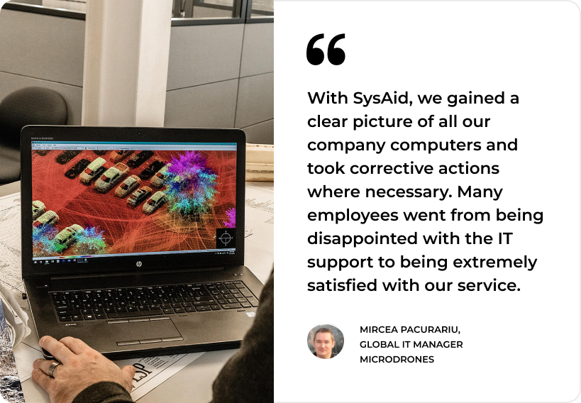 A person points at a laptop screen with data visualization, highlighting SysAid's impact on ITSM for enhanced IT satisfaction. - SysAid