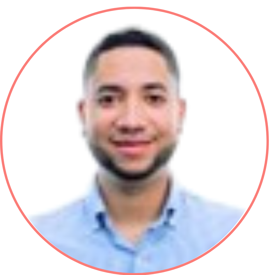 A headshot of a smiling man with short black hair in a blue shirt, encircled by a pink border.